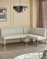 Light grey faux-leather left-hand corner bench with stainless steel frame, displayed in modern living room setting.