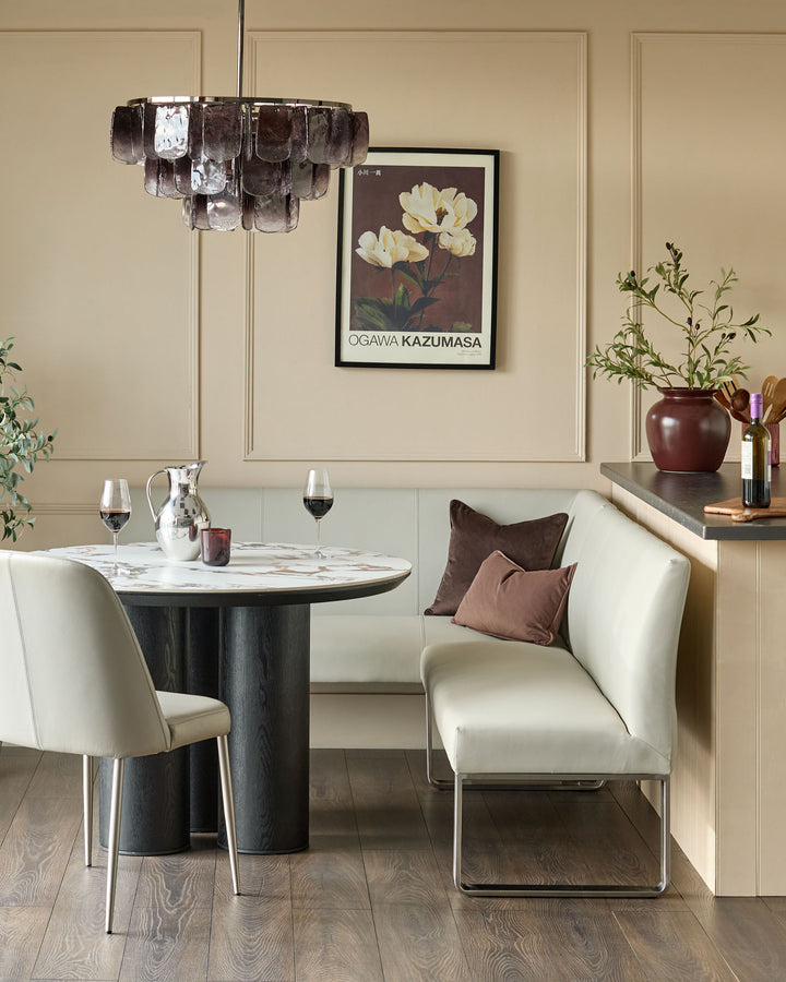 Light grey faux-leather right-hand corner bench with stainless steel frame, shown in a modern dining room setting.