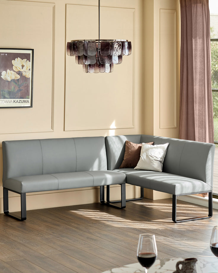 Grey upholstered left-hand corner bench with black metal legs, styled in modern living room with decorative pillows.