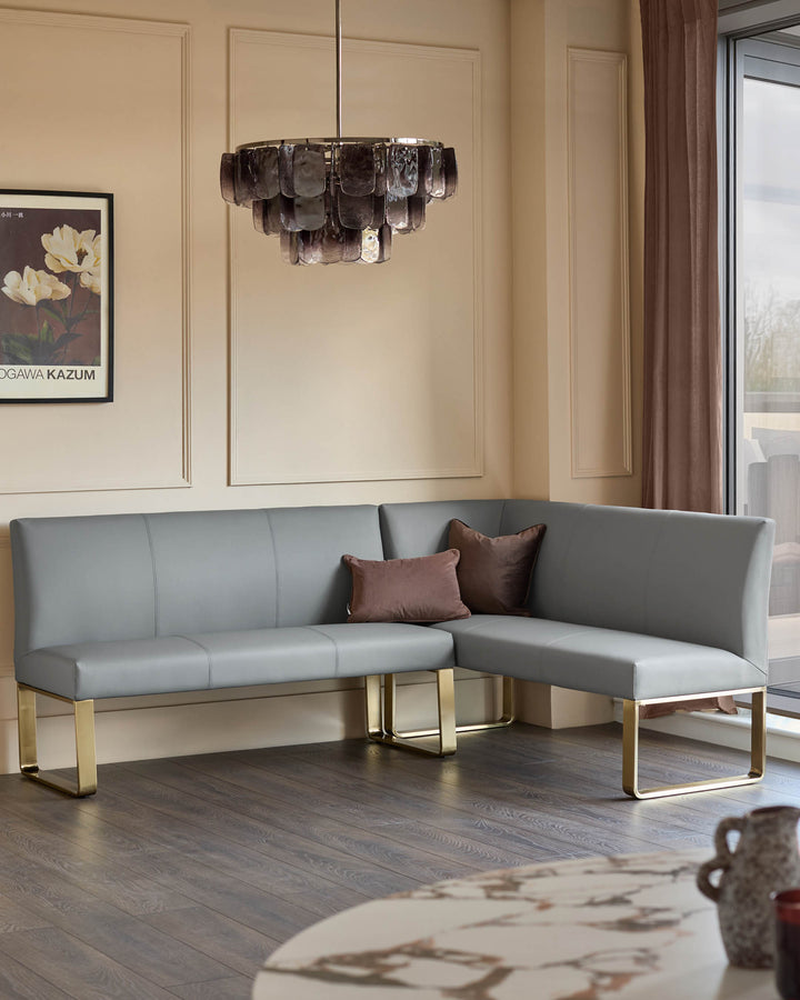 Loop 5-seater left-hand corner dining bench in mid-grey faux leather with brushed brass legs, styled in modern room.