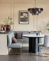 Loop 5-seater left-hand corner dining bench with brushed brass legs in mid-grey faux leather, styled in dining setting.
