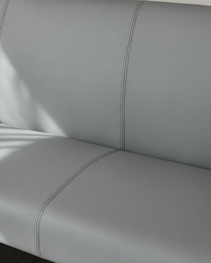 Light grey faux leather dining bench corner section with double stitching detail and chrome leg base visible.