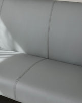 Light grey faux leather dining bench corner section with decorative stitching detail and chrome legs.