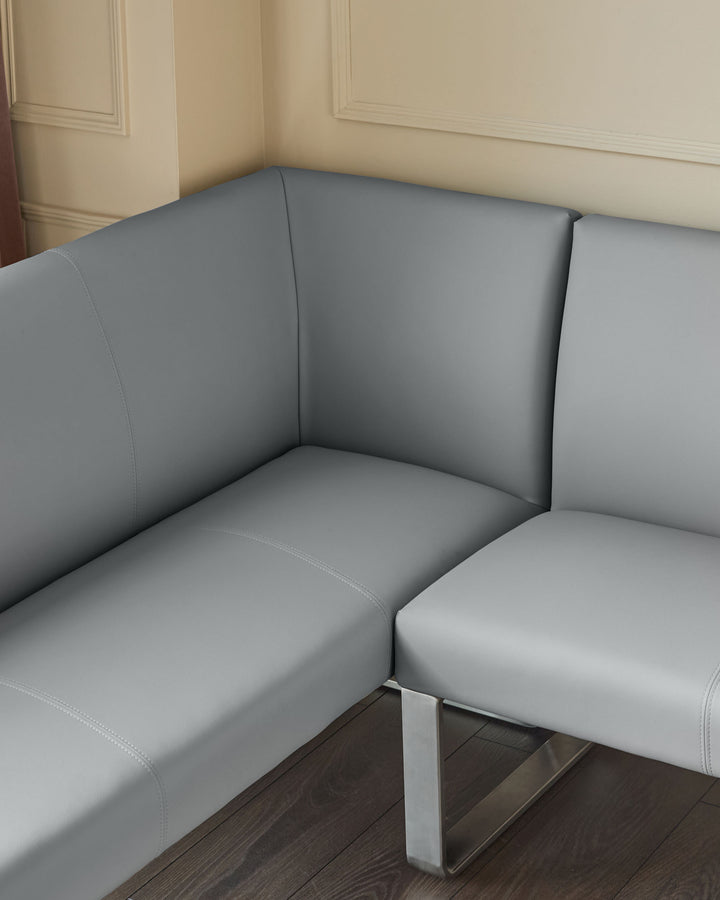 Grey faux-leather left-hand corner bench with stainless steel frame, showing cushioned seating and backrest detail.