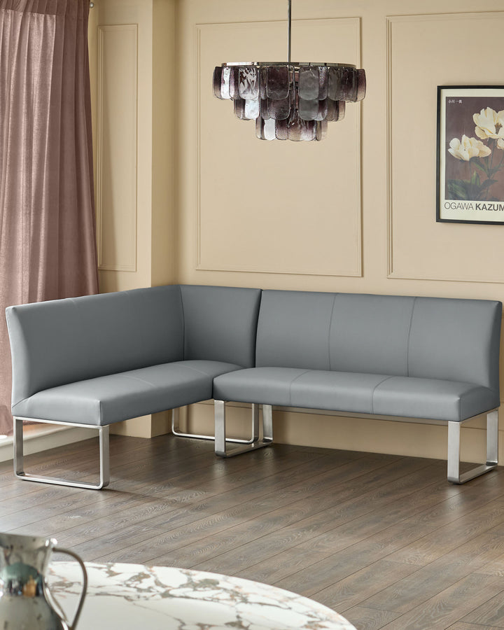 Grey faux-leather left-hand corner bench with stainless steel frame, displayed in modern living room setting.