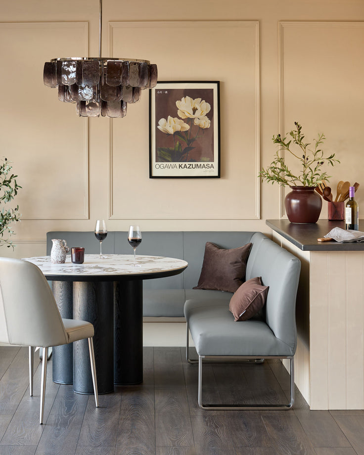 Loop 5-seater left-hand corner bench in mid-grey faux leather with stainless steel frame, styled in modern dining setting.