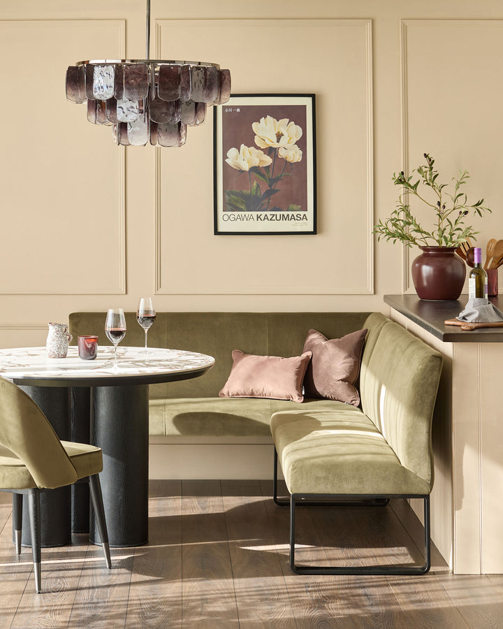 Loop 5-seater right-hand corner bench in olive green velvet with black metal legs, shown in dining setting.