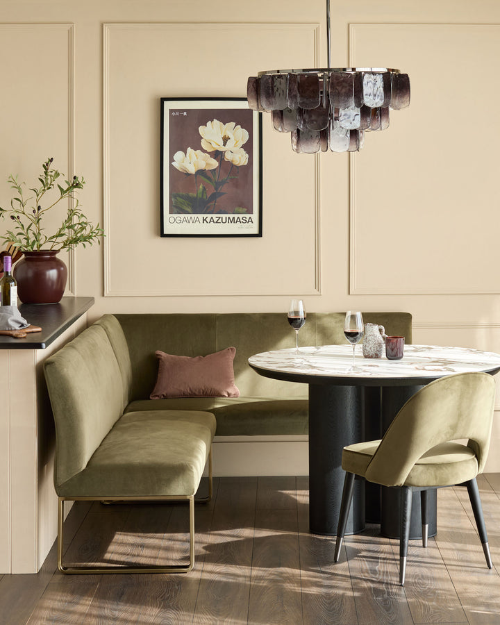 Smoked ombre glass chandelier with cylindrical shade in brown and white tones, suspended above a dining table.