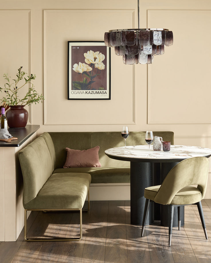 Smoked ombre glass chandelier with cylindrical shade in brown and white tones, suspended above a dining table.