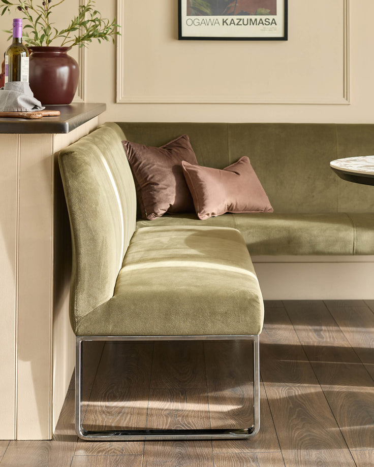 Olive green 5-seater left-hand corner bench with chrome legs, burgundy and mauve cushions, displayed in modern interior.