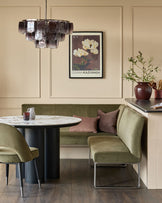 Loop 5-seater right-hand corner bench with stainless steel legs in olive green, styled in a modern dining space.