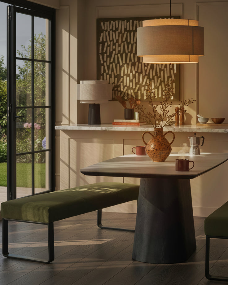 Loop 3-seater velvet bench without backrest in olive green with black metal legs, shown in modern dining setting.