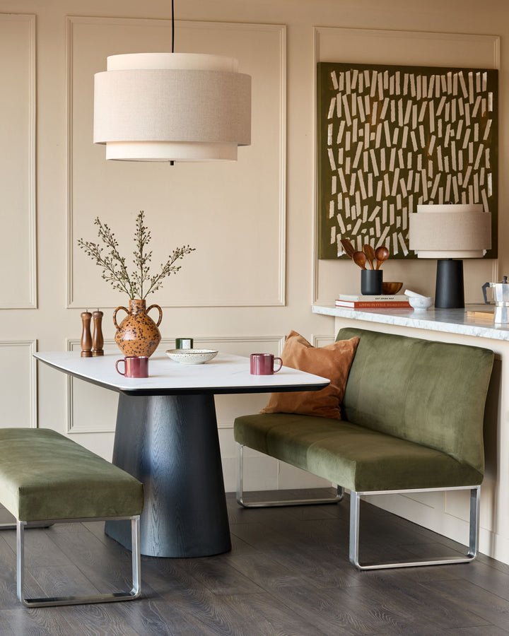 Loop 3-seater velvet bench without backrest in olive green with stainless steel frame, shown in modern dining setting.