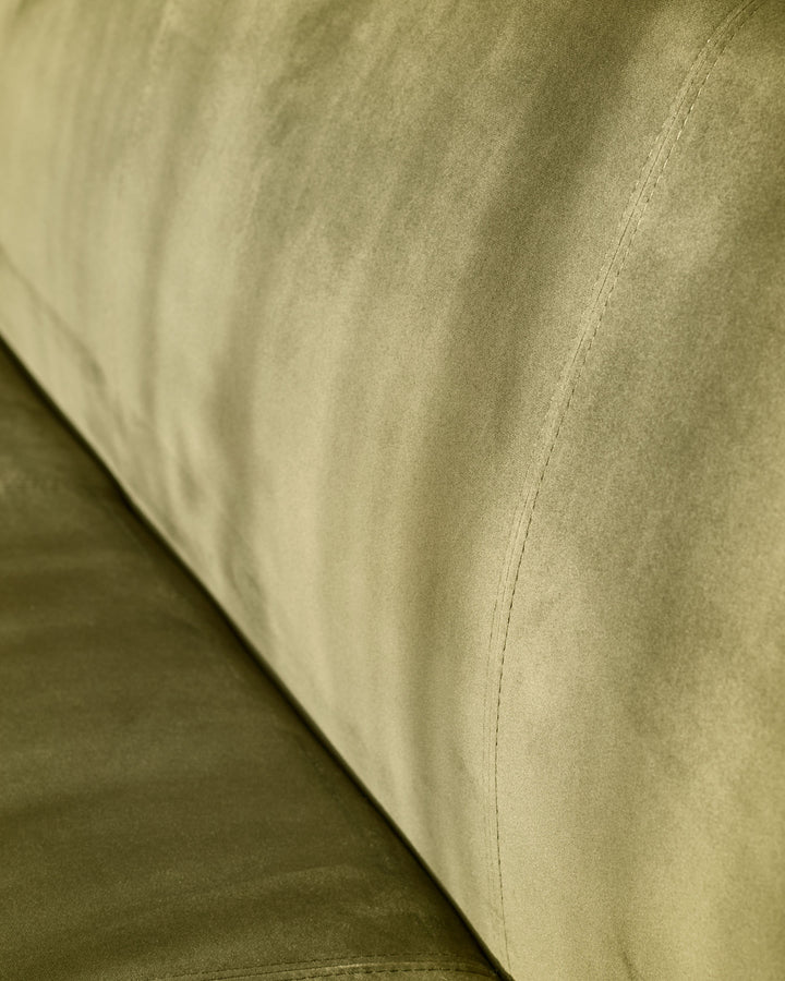 Close-up of olive-green velvet upholstery on 3-seater bench, showing fabric texture and seam detail.