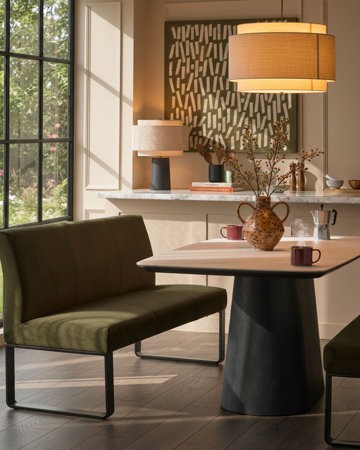 Loop 3-seater velvet bench with backrest in olive green, black metal frame, shown in modern dining setting.