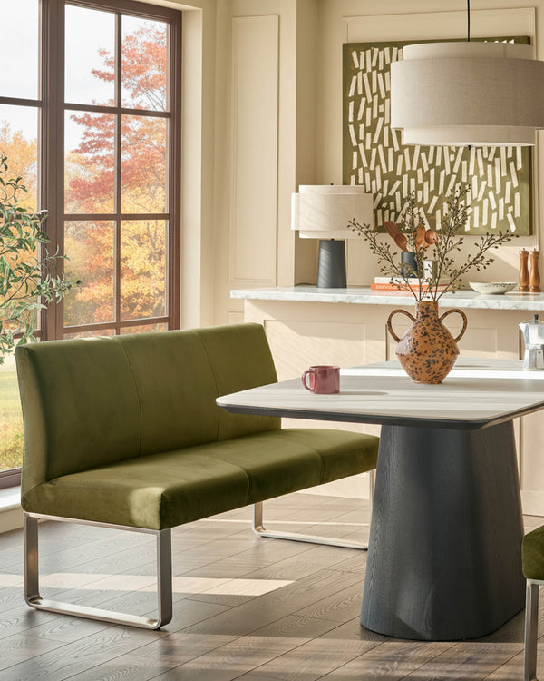 Loop 3-seater velvet bench with backrest in olive green, stainless steel frame, styled in modern kitchen setting.