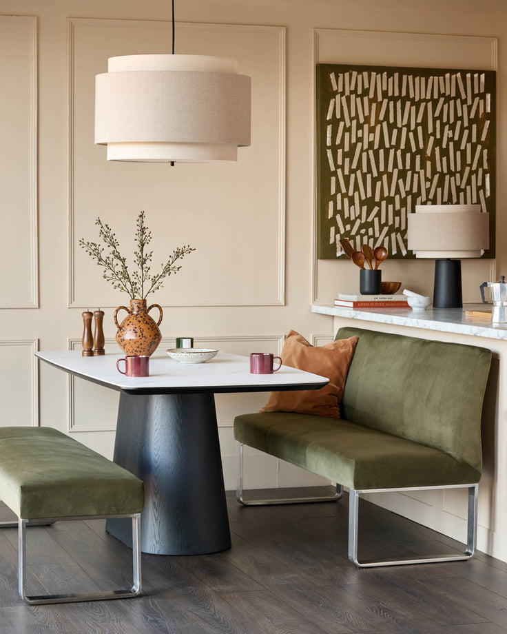 Loop 3-seater velvet bench with backrest in olive green, stainless steel frame, styled in modern dining space.