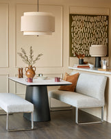 Loop 3-seater fabric bench without backrest in grey, stainless steel frame, shown in modern dining setting.