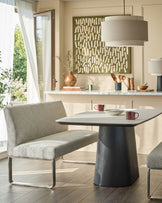 Grey fabric 3-seater bench with backrest and stainless steel frame, shown in modern dining setting.
