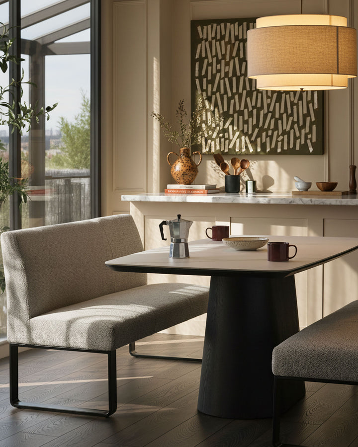 Grey fabric 3-seater bench with backrest and black metal frame, shown in a modern kitchen setting.