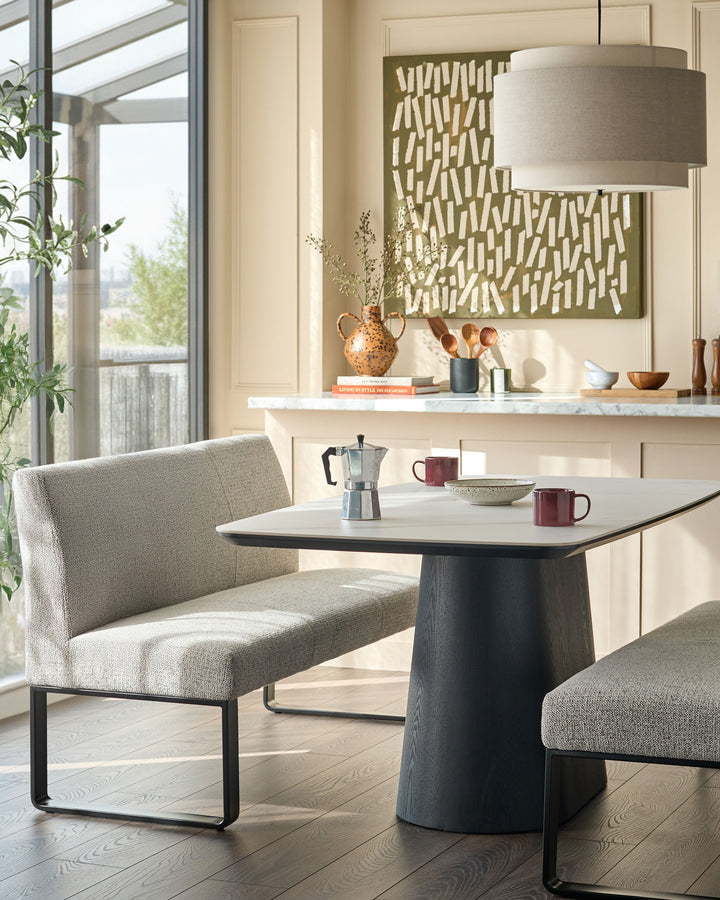 Loop 3-seater fabric bench with backrest in grey, featuring black metal frame, shown in modern dining setting.