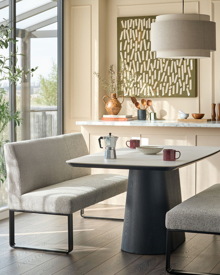 Loop 3-seater fabric bench with backrest in grey, featuring black metal frame, shown in modern dining setting.
