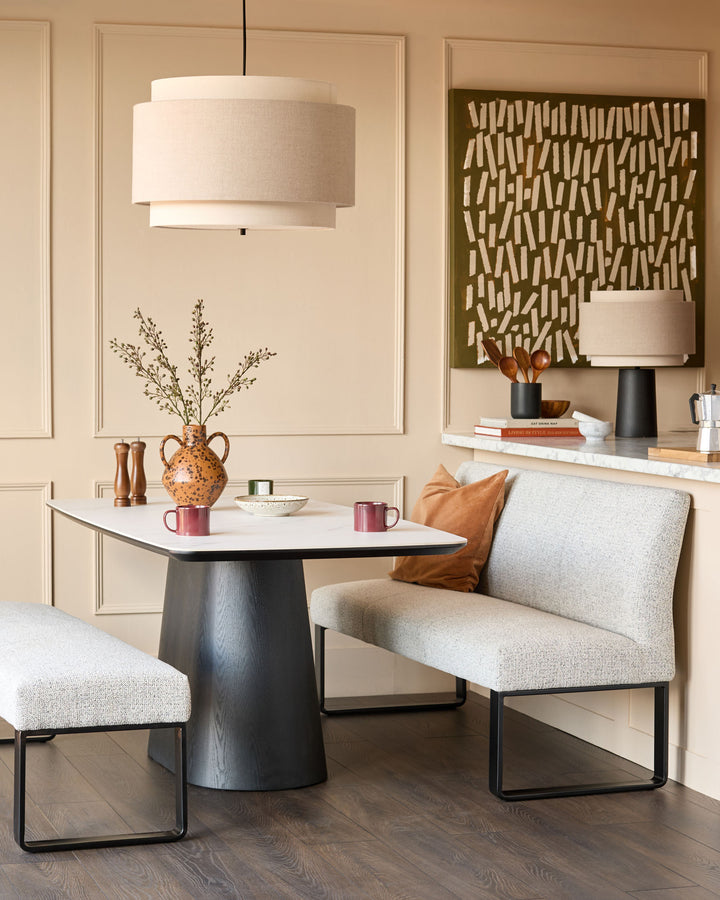 Loop 3-seater fabric bench with backrest in grey fabric and black metal frame, shown in a styled living room setting.