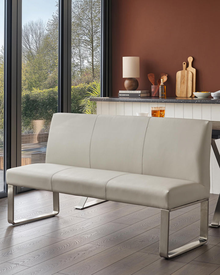 A stylish grey dining bench with a metal frame, complementing a contemporary kitchen-diner setting.