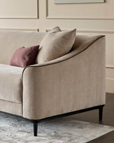 Julep champagne fabric 3-seater sofa with black wooden legs, shown from side angle with decorative pillows.