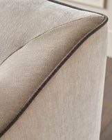 Close-up of champagne fabric on Julep Blackwood 2-seater sofa showing soft texture and piping detail.