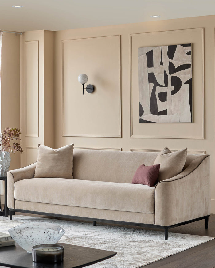 Champagne fabric 3-seater sofa with curved arms and black wooden legs, styled in a neutral living room setting.
