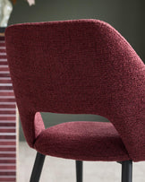 Close-up of a claret-upholstered chair with black legs, showing the backrest and seat.