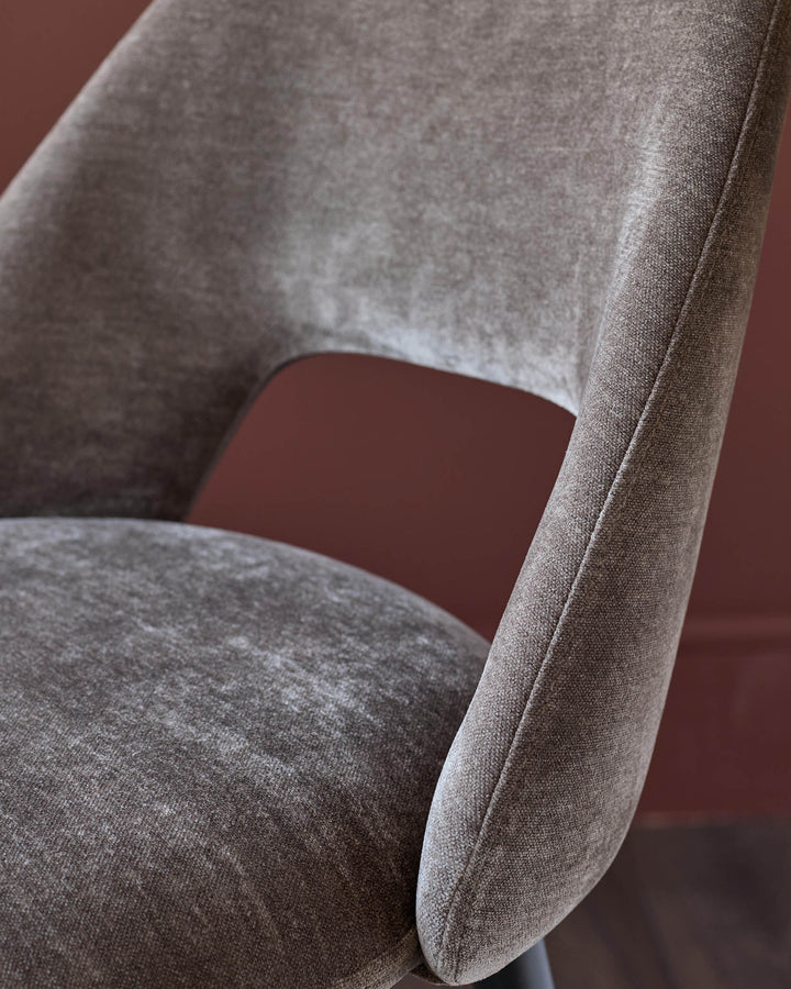 Close-up of a stylish brown upholstered chair. Modern design, perfect for a contemporary dining room.