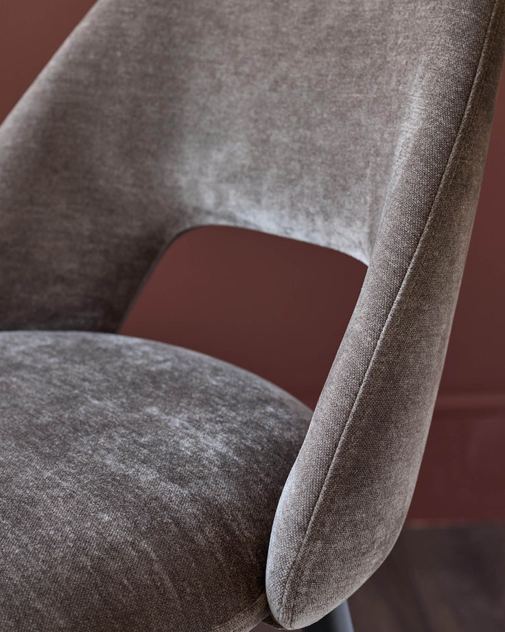 Close-up of a stylish brown upholstered chair. Modern design, perfect for a contemporary dining room.