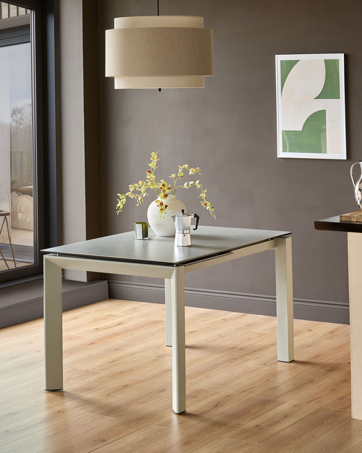 Louis extending dining table in light grey with black ceramic top, shown in modern kitchen setting with natural wood flooring.