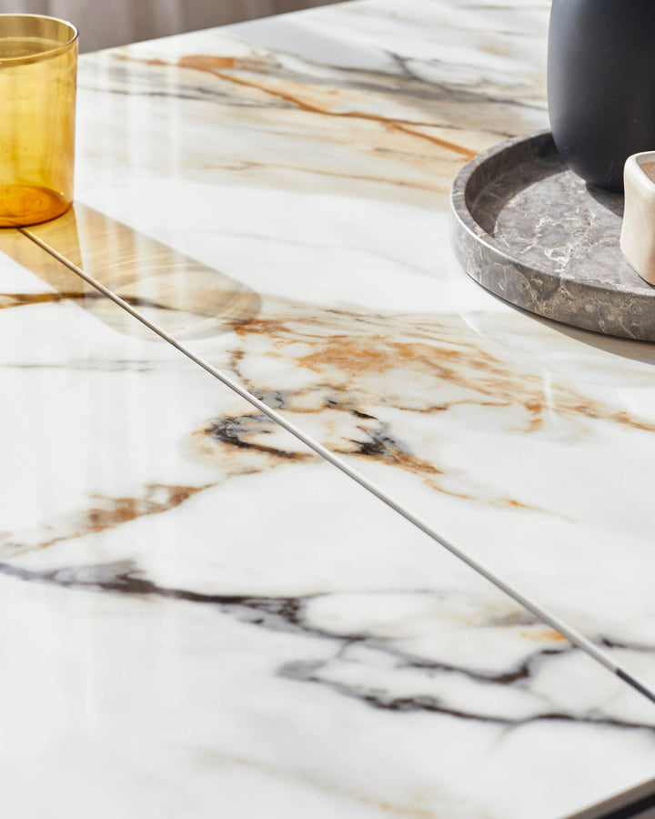 A stylish marble table with neutral-toned accessories, perfect for a modern living or dining room.