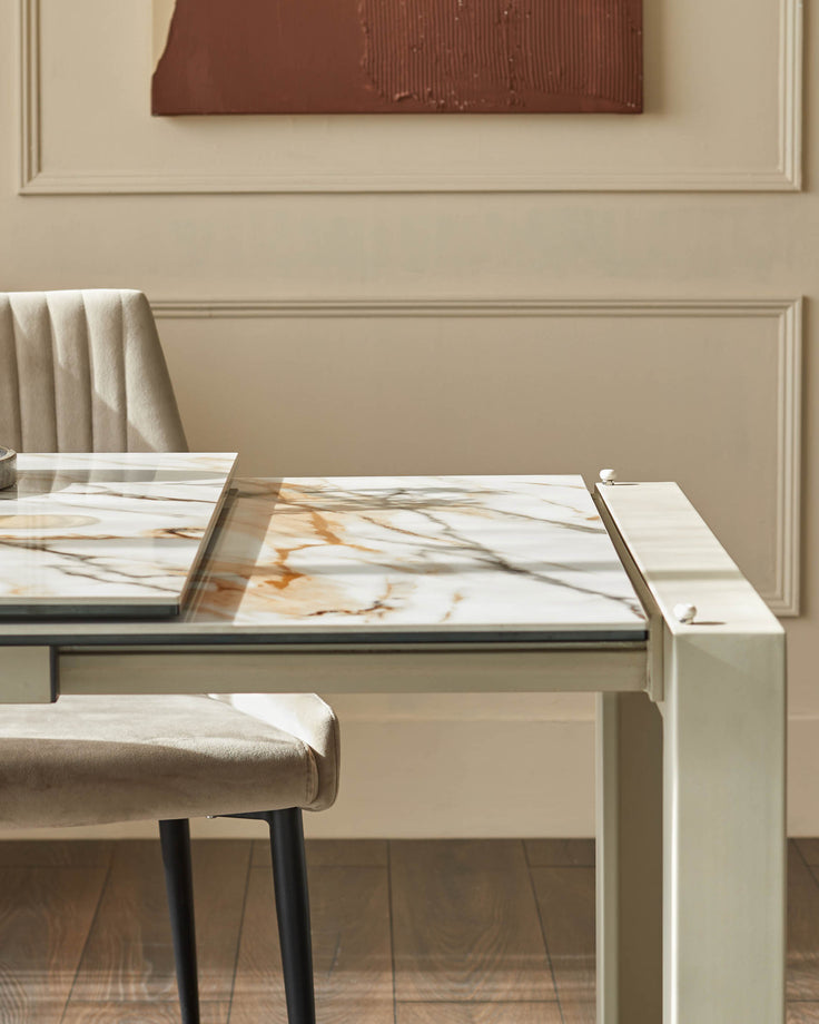 A modern dining area with a marble-topped table and stylish upholstered chairs, blending luxury with minimalist design.