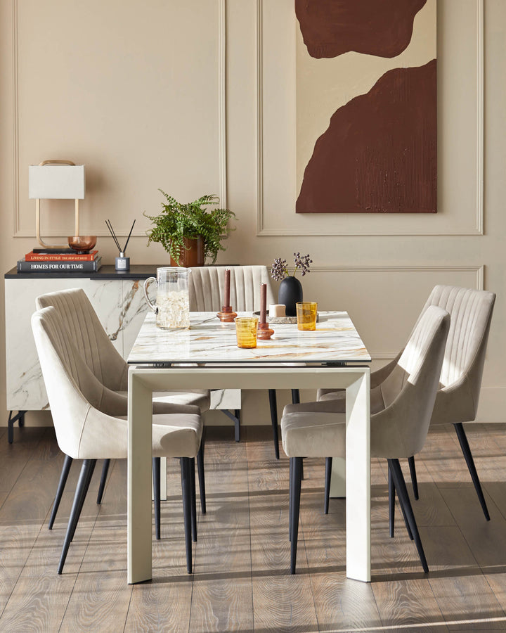Dining room setup with marble table, four cushioned chairs, and a sideboard with a lamp and decorative items.