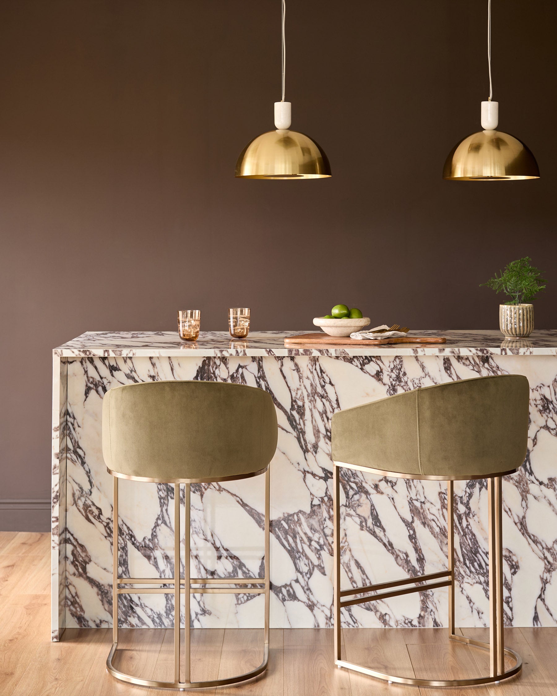 Louis single pendant lamp in brass finish with cream cord and dome-shaped shade, shown in interior setting.