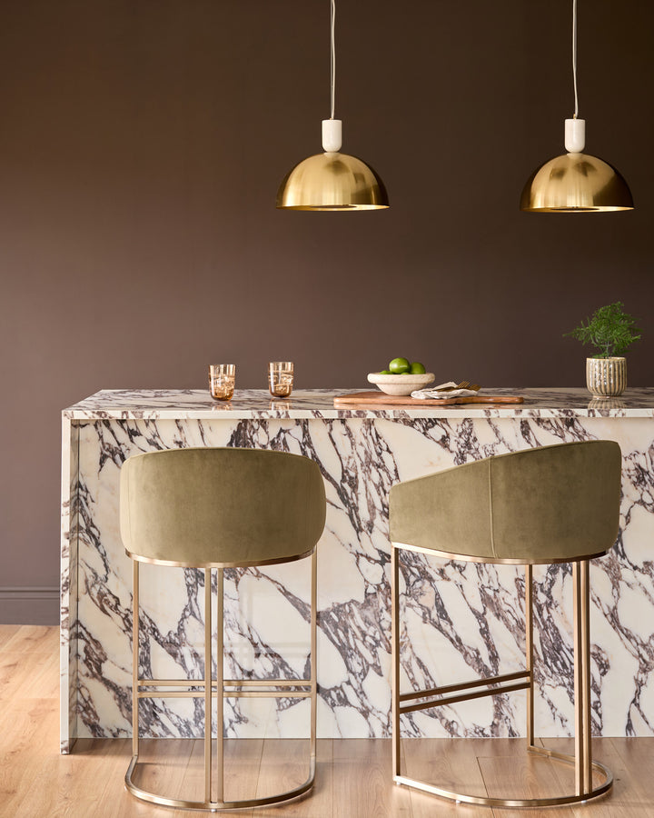 Louis single pendant lamp in brass finish with cream cord and dome-shaped shade, shown in interior setting.