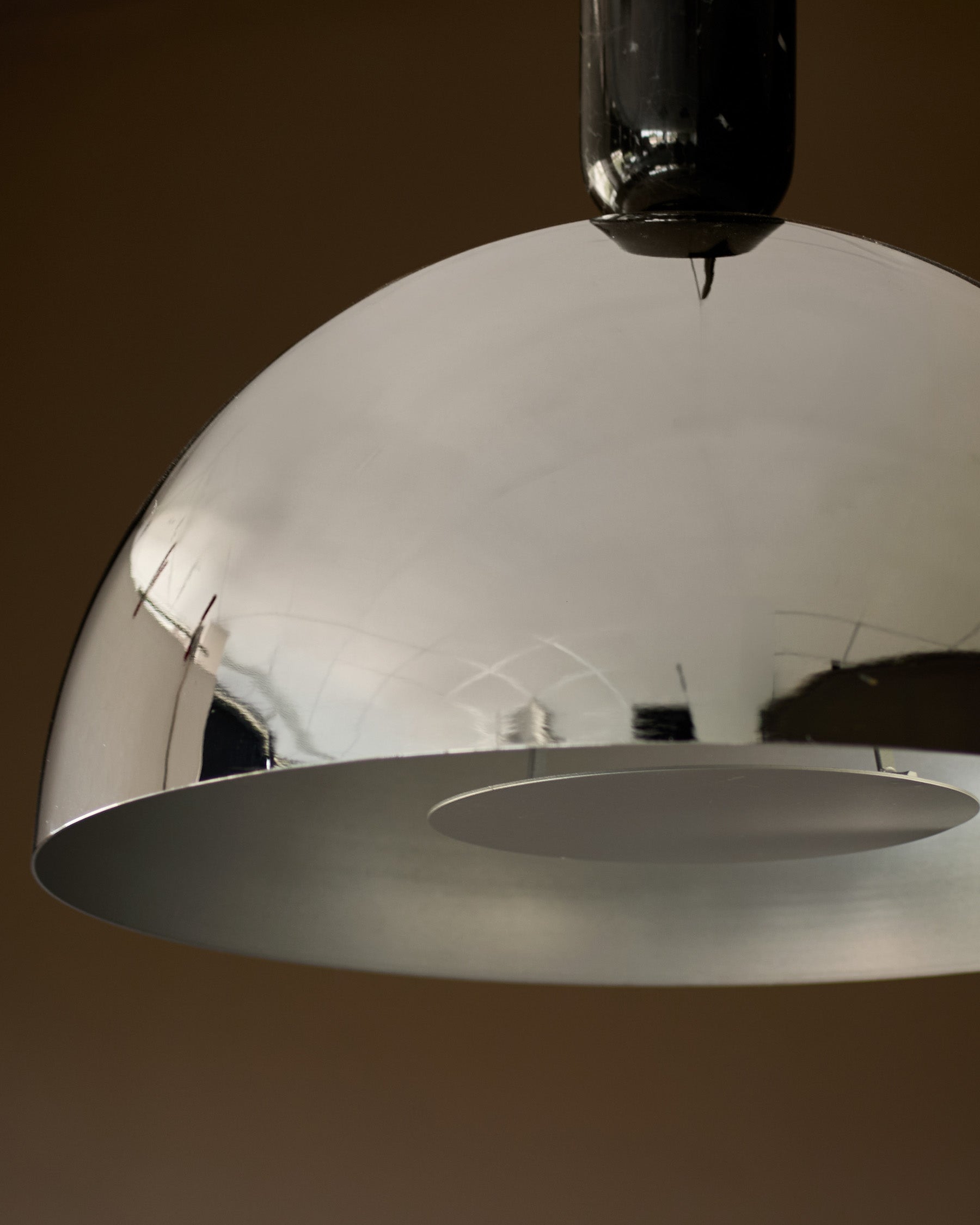 Louis single pendant light in chrome with dome shade and black cord detail, shown at an angle against neutral background.