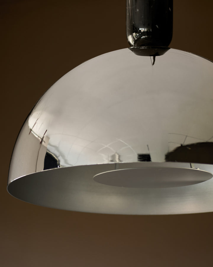 Louis single pendant light in chrome with dome shade and black cord detail, shown at an angle against neutral background.