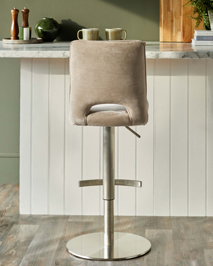 A stylish bar stool with a cushioned back and metal base, perfect for adding a touch of modern elegance to your kitchen or bar area.