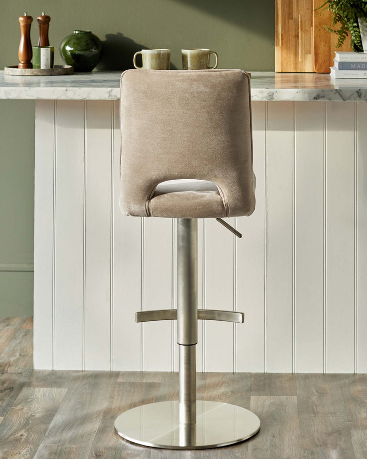 A stylish bar stool with a cushioned back and metal base, perfect for adding a touch of modern elegance to your kitchen or bar area.