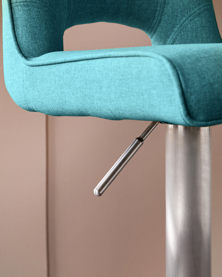 Light teal fabric gas lift bar stool with brushed stainless steel base, shown in side detail view.