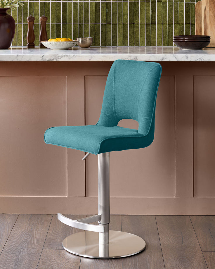 Ludo light teal fabric gas-lift bar stool with brushed metal pedestal base, shown in modern kitchen setting.