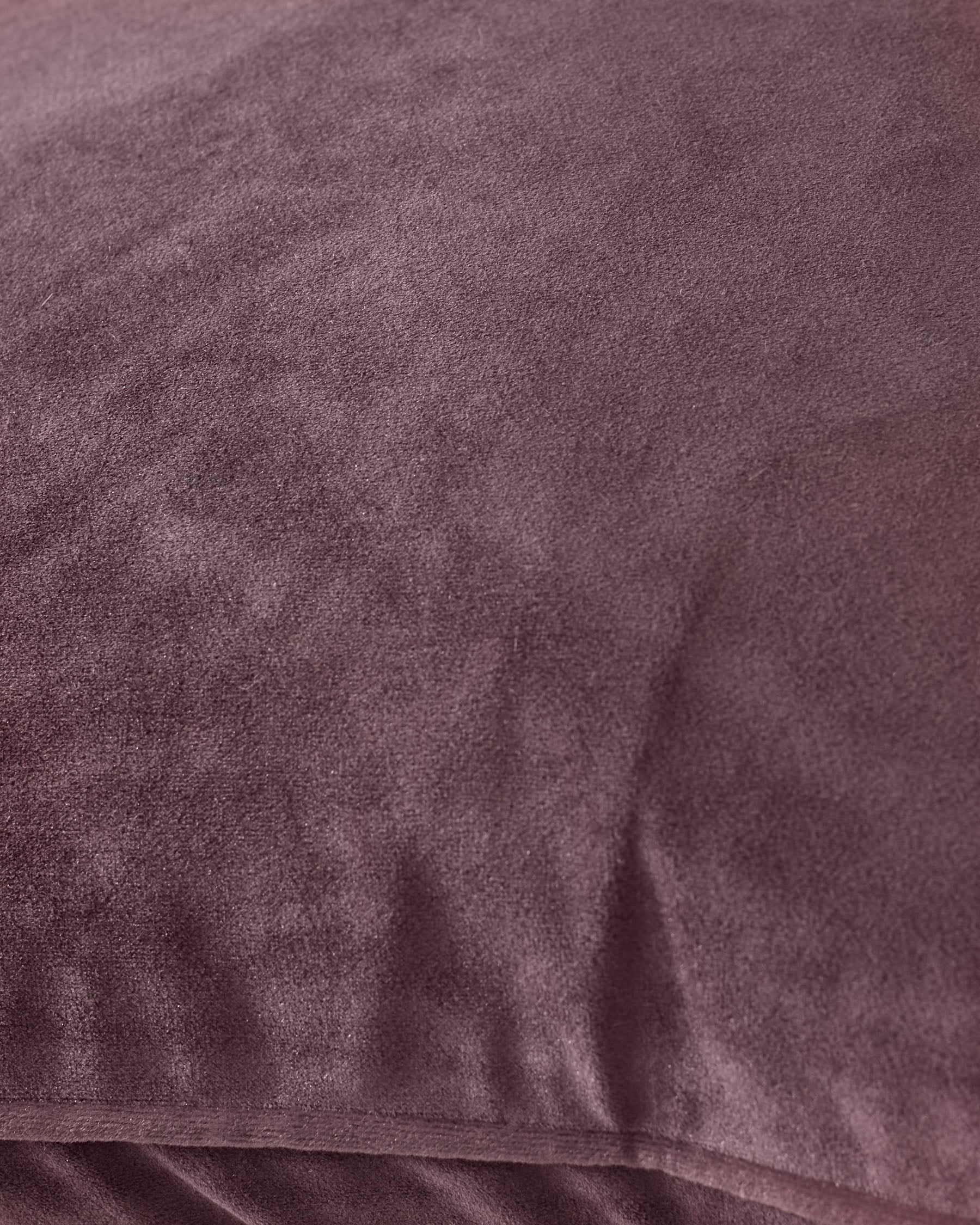 Luca cushion in mulberry, close-up detail showing soft velvet texture and fabric weave.