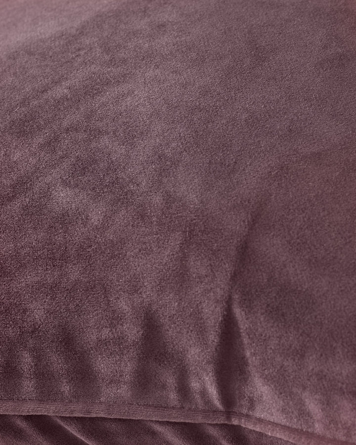 Luca cushion in mulberry, close-up detail showing soft velvet texture and fabric weave.
