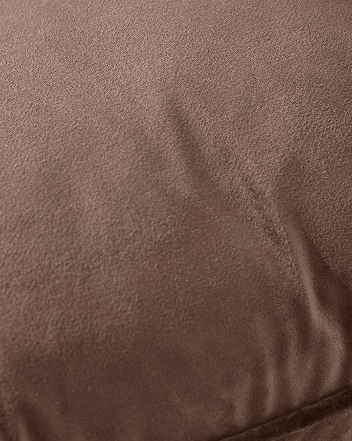 Luca Rectangle Cushion in chocolate brown, close-up showing soft textured fabric with subtle fold detail.
