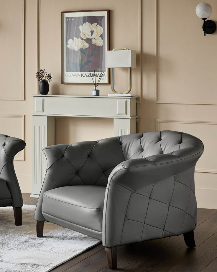 A stylish grey leather armchair sits on a rug in front of a decorative fireplace, blending comfort and elegance.